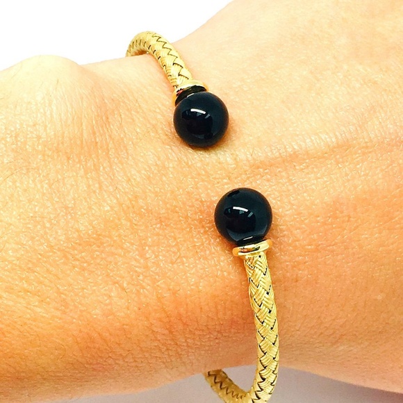 An attractive multi gem floral art deco bracelet, Van Cleef  Daniel Waknine 18k Black Onyx Cuff Bracelet